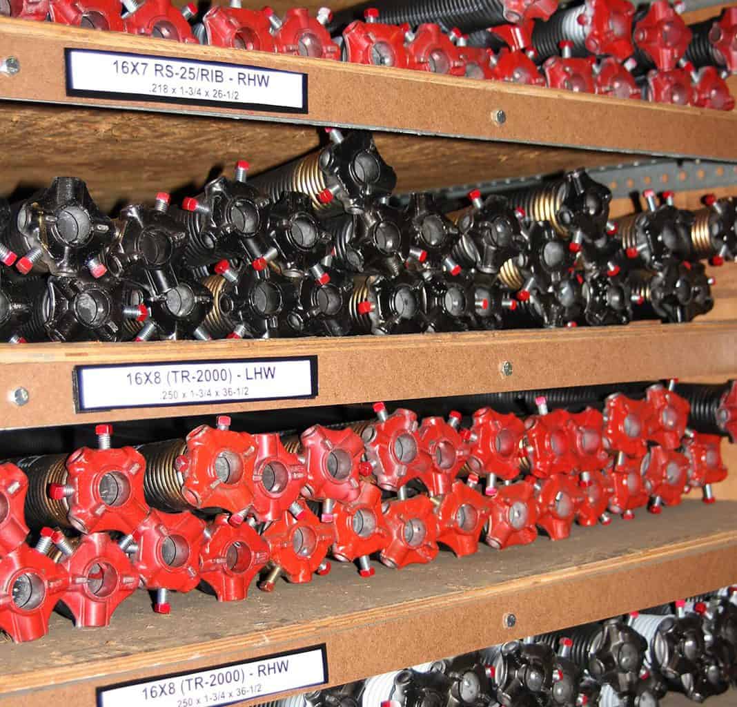Garage Door Torsion Springs on a rack in our warehouse