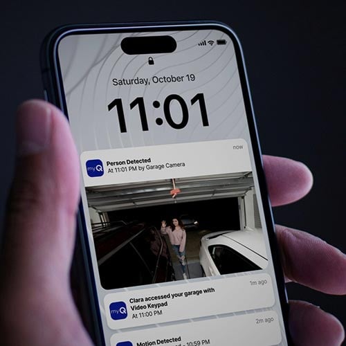 Person viewing the myQ garage door app on their smartphone.