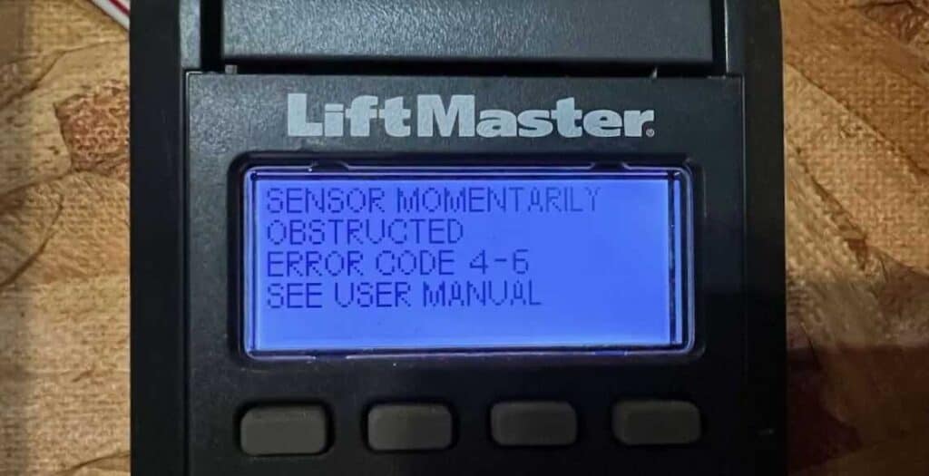 A LiftMaster display screen shows SENSOR MOMENTARILY OBSTRUCTED ERROR CODE 4-6 SEE USER MANUAL on a blue backlit screen. This may indicate a Garage Door Sensor Alignment issue—check and align Garage Door Sensors using the manual.